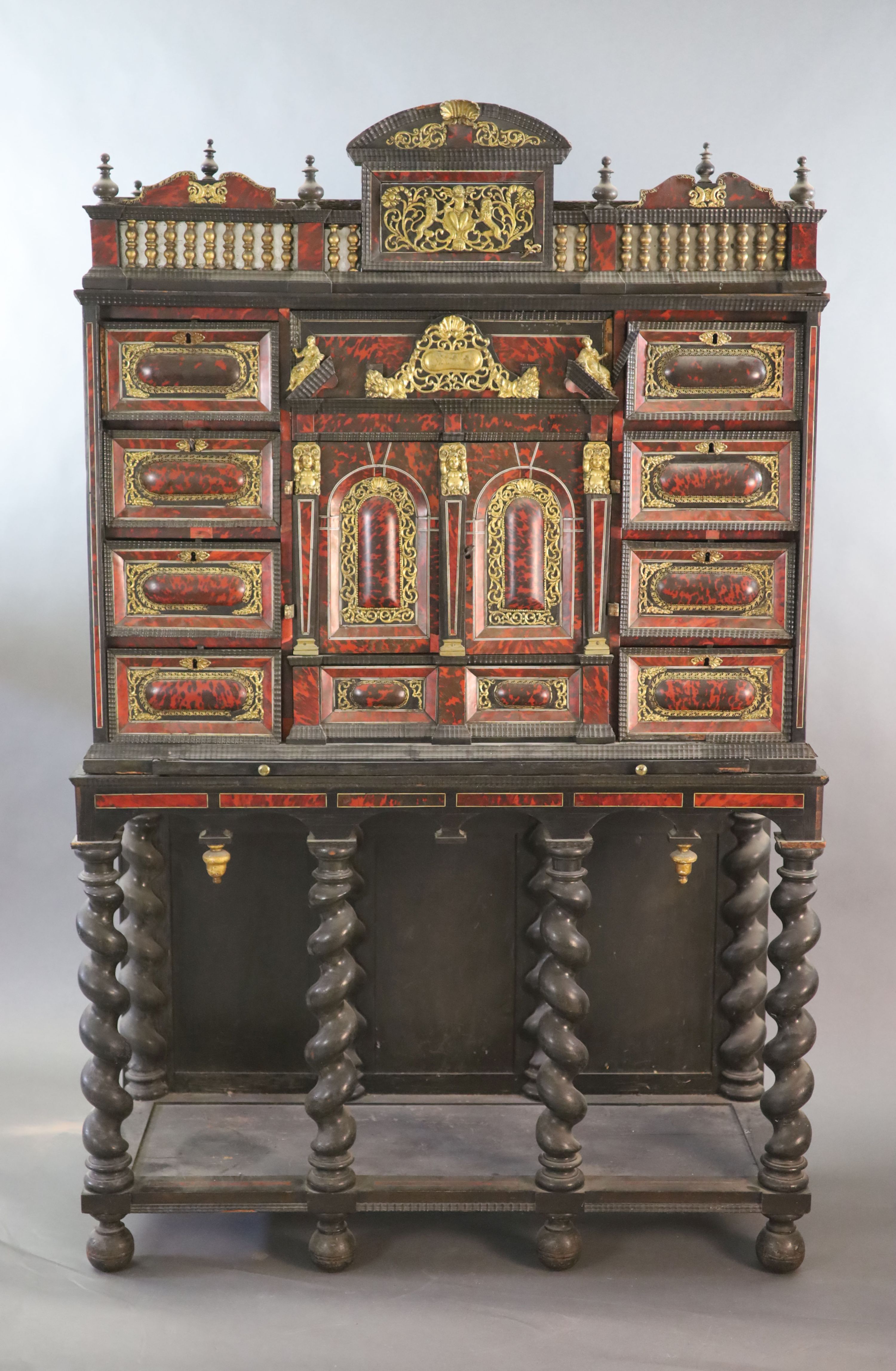 A late 17th century Portuguese ormolu mounted ebony and red tortoiseshell cabinet on stand, W.124cm D.46cm H.187cm